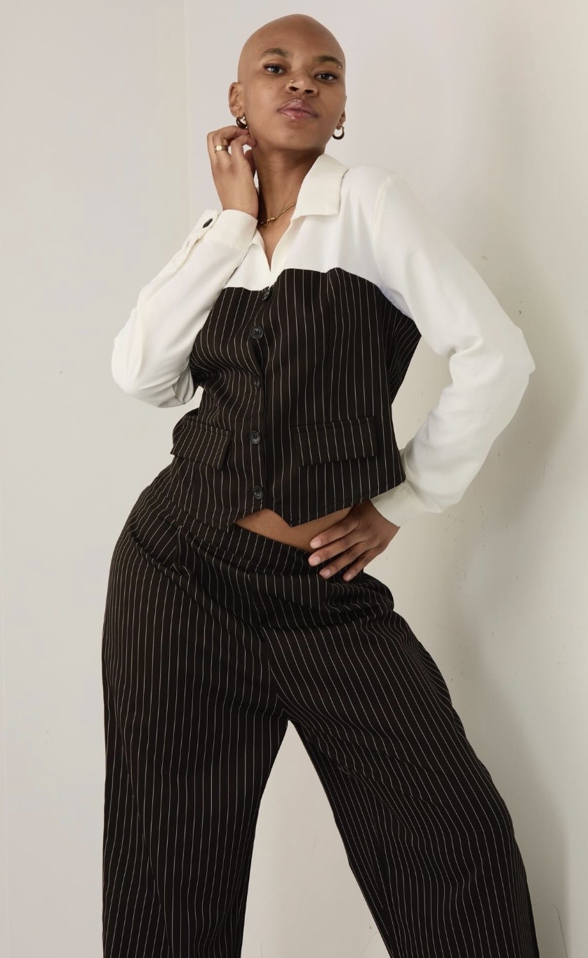 Cameron Hilliard in a pinstripe corset suit, photographed in studio